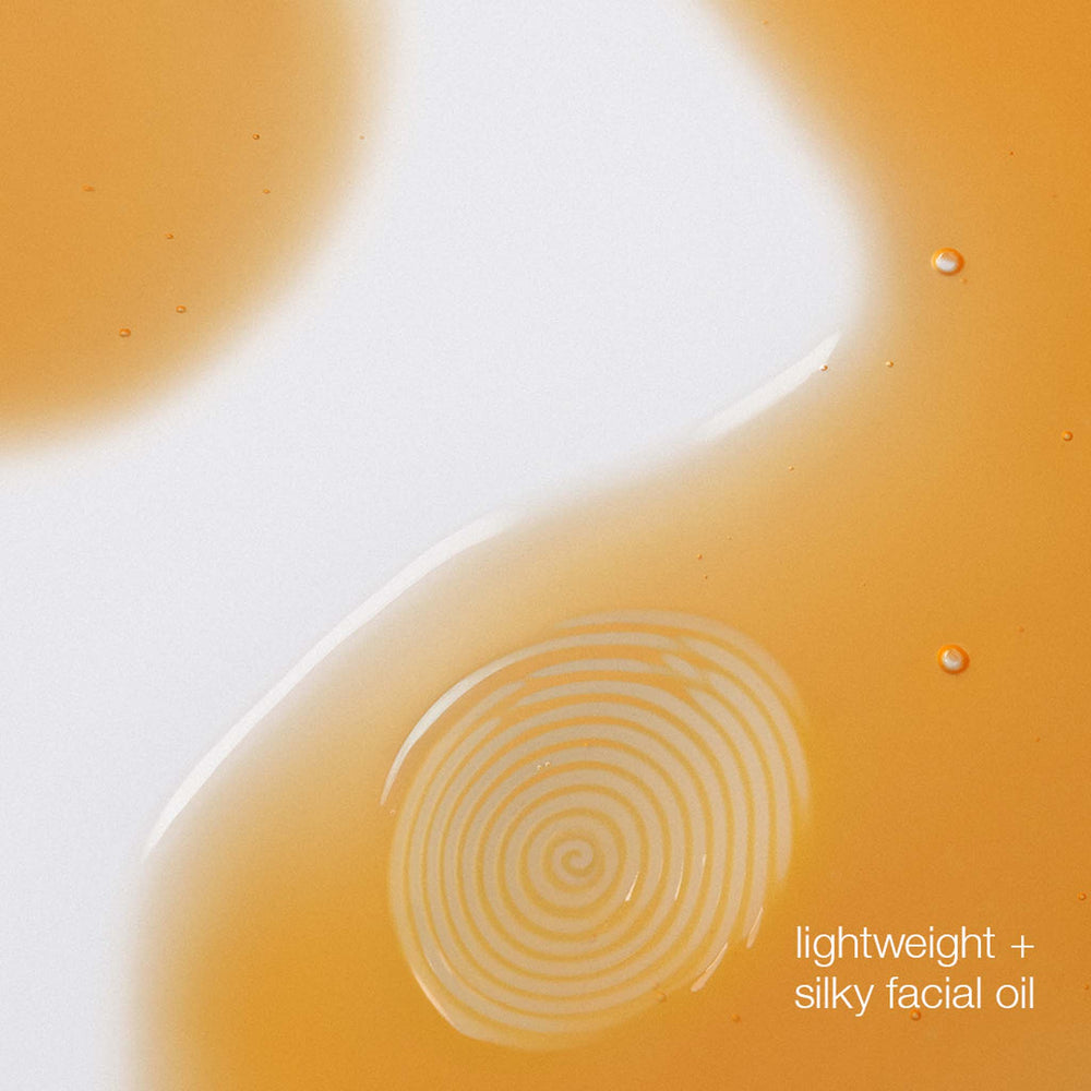 Close-up of a droplet of facial oil with concentric circles and text 'lightweight + silky facial oil'