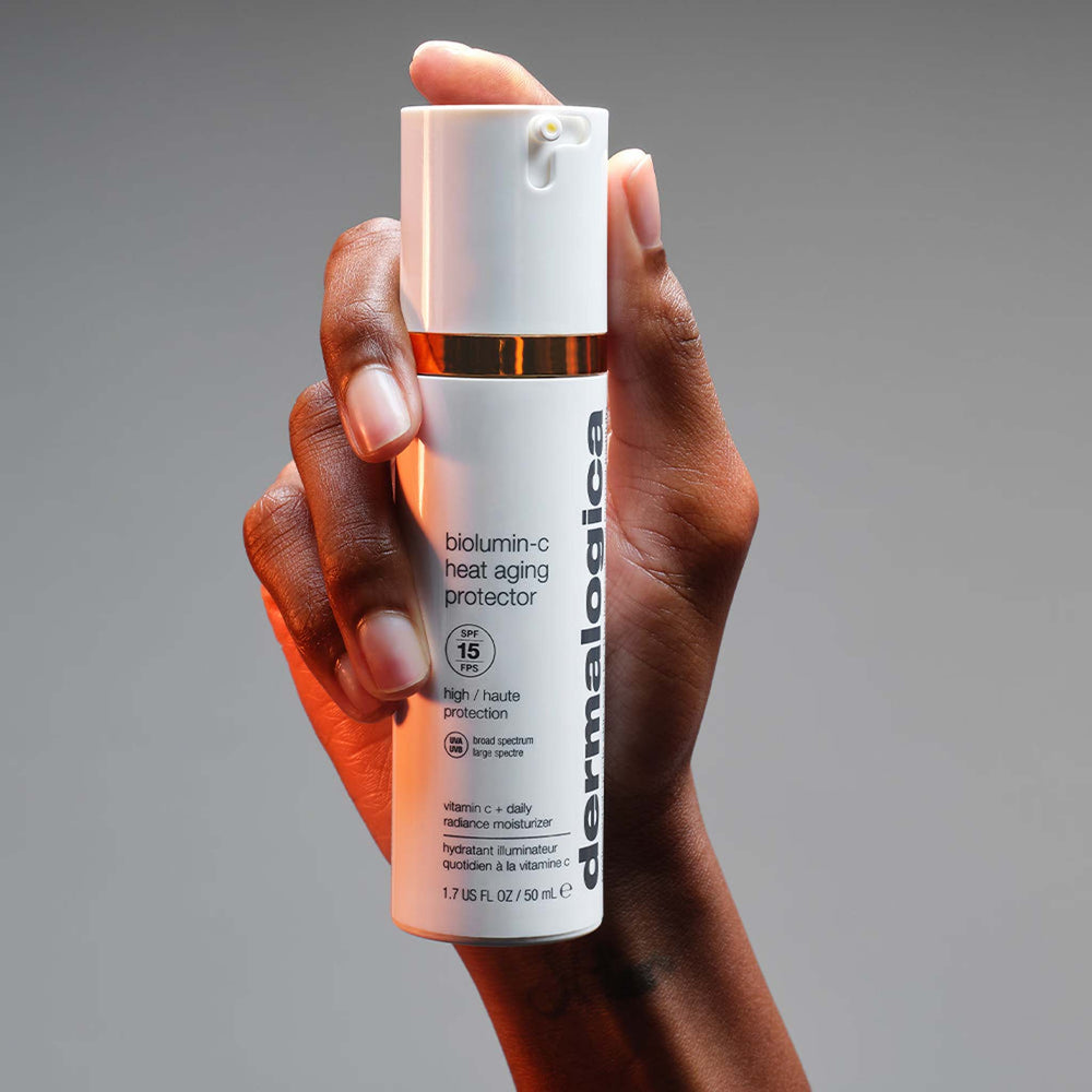 Hand holding a biolumin-c heat aging protector spf15