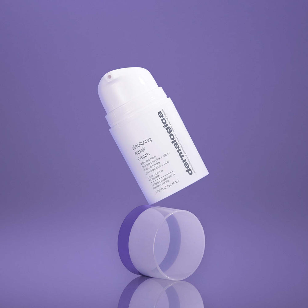 dermalogica stabilising repair cream bottle on a reflective purple surface with a purple background